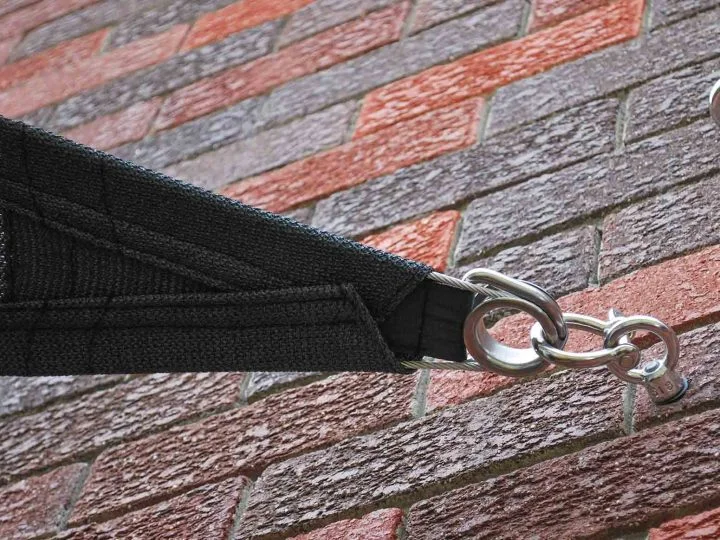 Stainless eye bolt and ring fixing a black shade sail to a brick wall