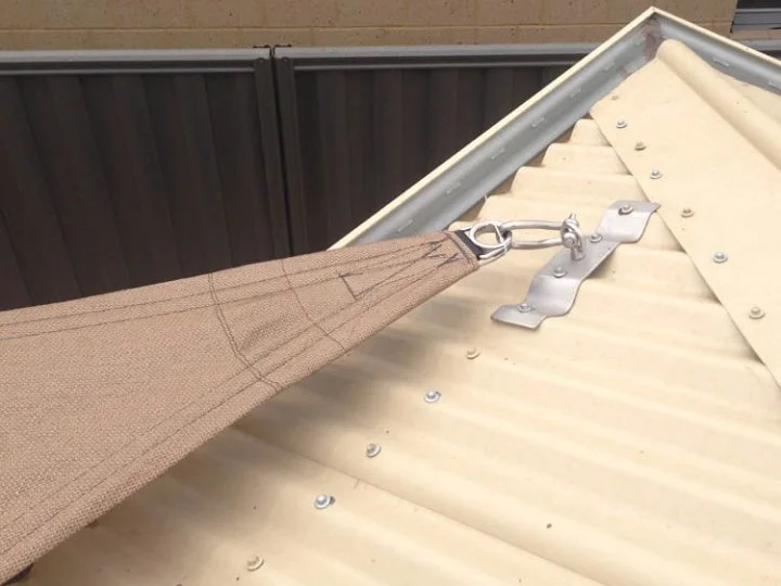 Stainless shade sail roof plate fixed across the ribs of a corrugated iron roof