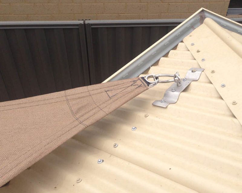 Stainless shade sail roof plate fixed across the ribs of a corrugated iron roof