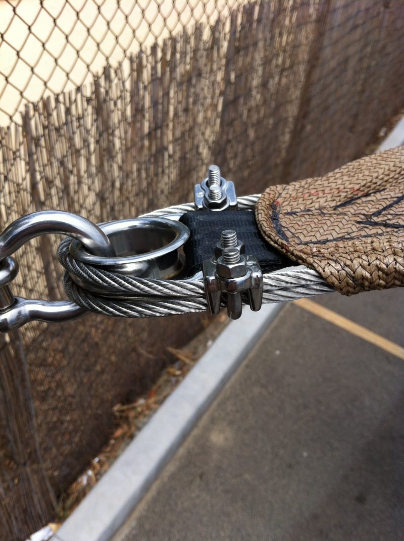 Perimeter wire rope with a stainless thimble, shackle and wire rope grips at a sail corner